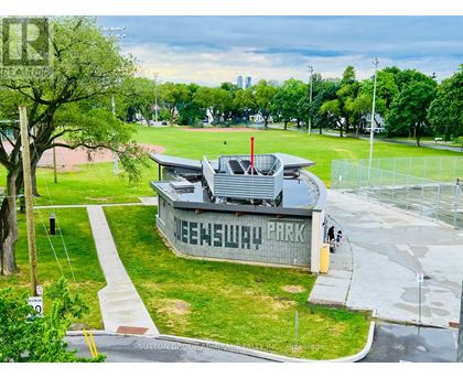 A park with a building that says "SNEWSLAP" on it.