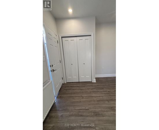 A white door is in a room with wood flooring.