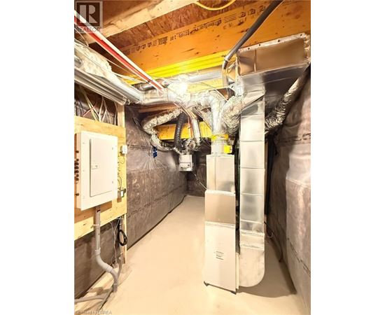 A room with a lot of pipes and ducts.