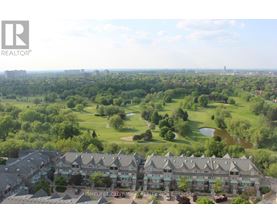 A bird's eye view of a golf course surrounded by buildings.