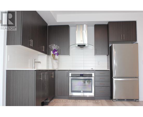 A modern kitchen with dark brown cabinets and stainless steel appliances.