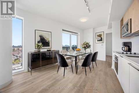 A modern kitchen with a dining table and chairs.