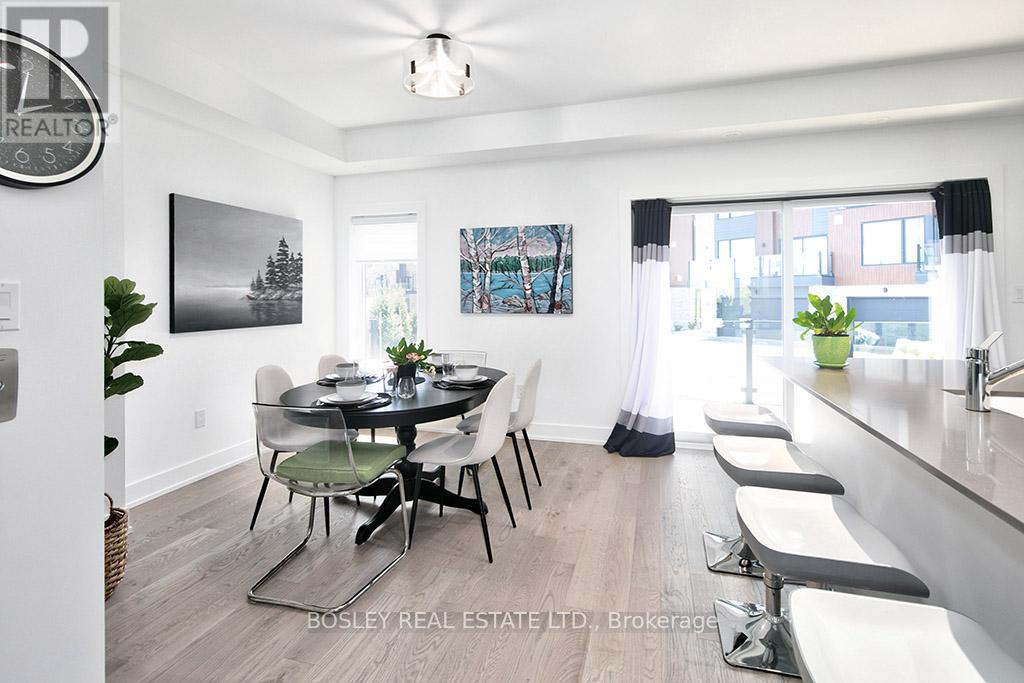 A dining room with a table set for four and a view of the city.