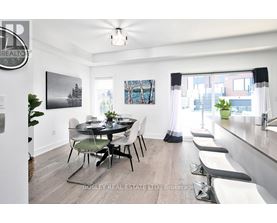 A dining room with a table set for four and a view of the city.