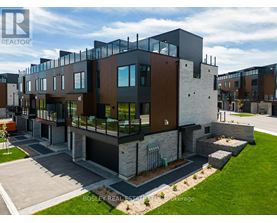 A modern multi-story residential building with a mix of dark and light exterior materials.