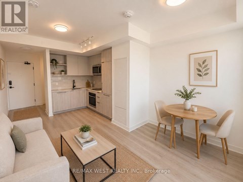 A modern living room with a dining table and chairs.