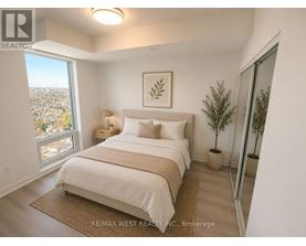 A bedroom with a large bed and a view of the city.