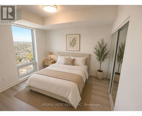 A bedroom with a large bed and a view of the city.