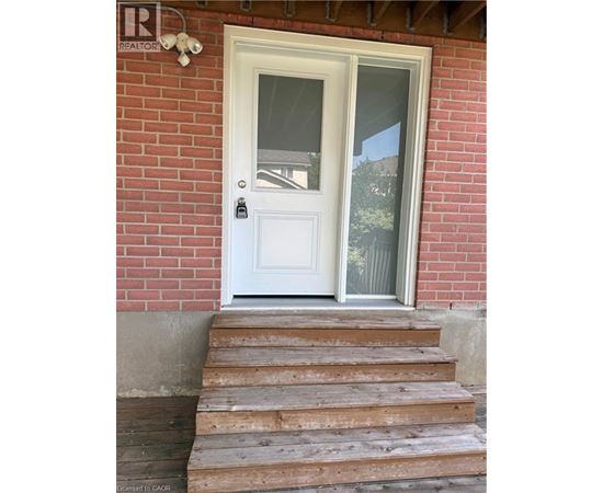 Steps leading to a white door with a glass window.