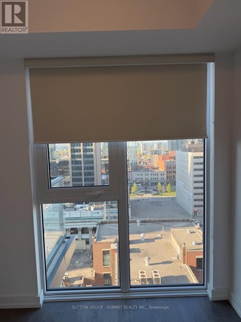 A window with a view of a cityscape and buildings.