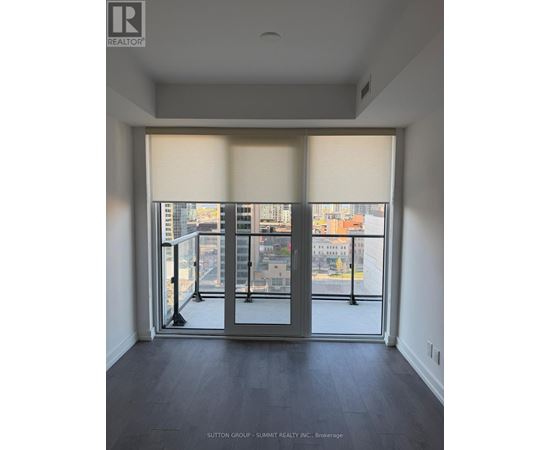 A room with a view of the city through large windows.