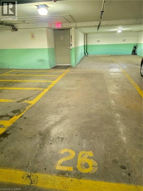 A parking garage with the number 26 painted on the ground.