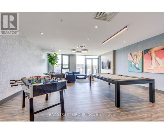 A pool table in a room with a view of the city.