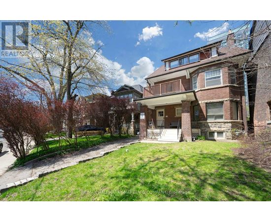A large house with a tree in front of it.