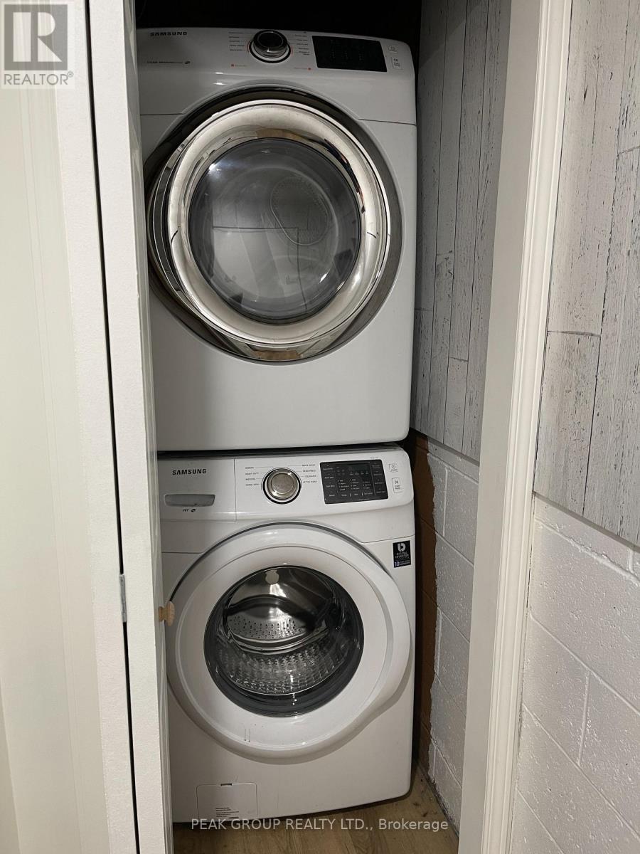 A white washing machine is in a small space.