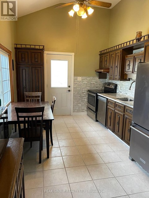 A kitchen with a table and chairs in front of a door.