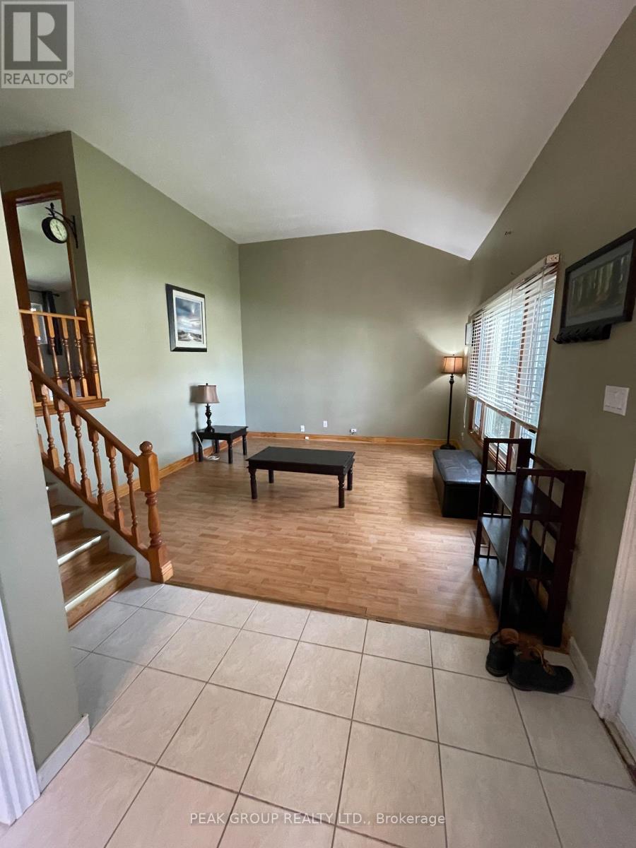 A living room with a staircase and a dog.