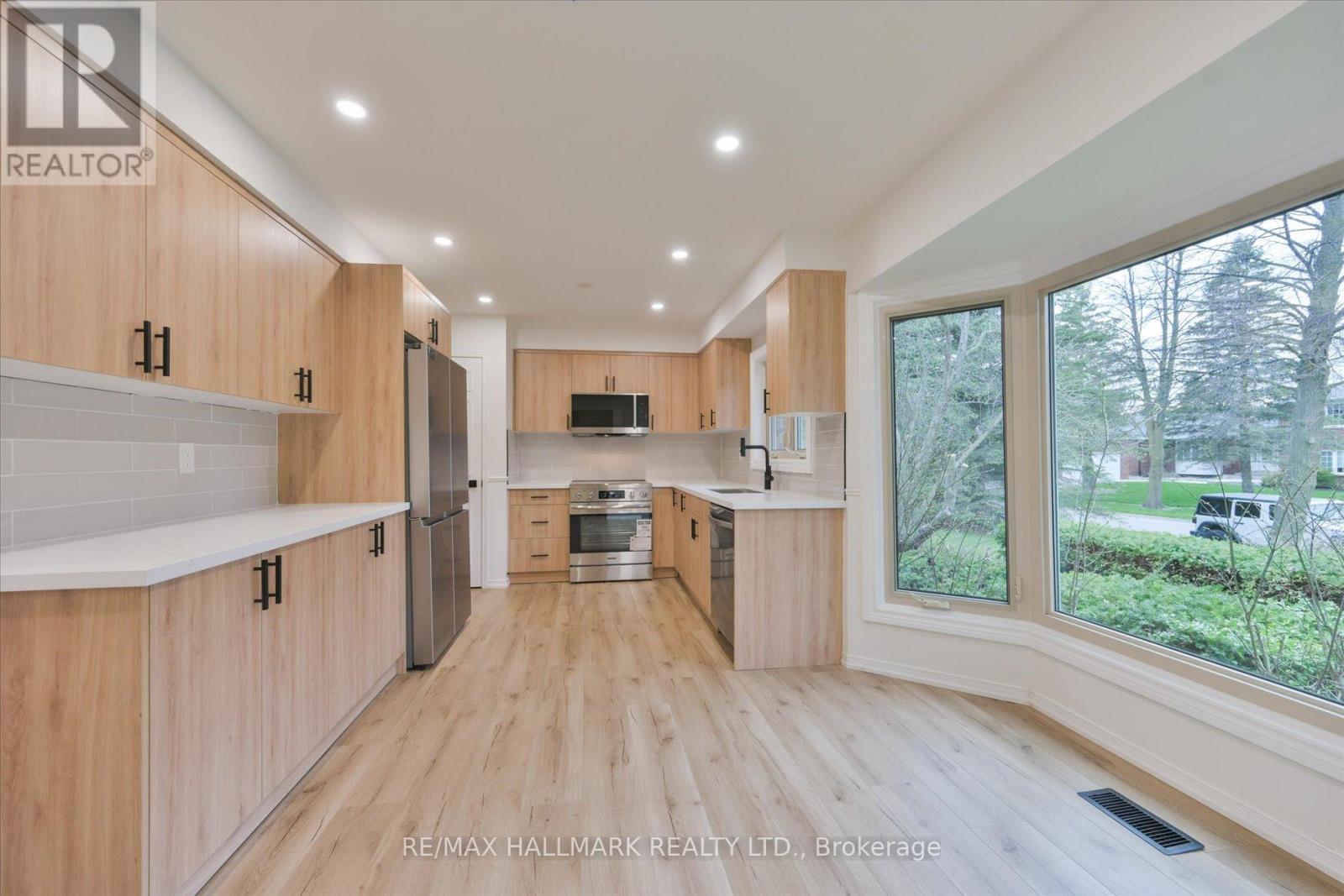 A spacious kitchen with wooden cabinets and a central island.