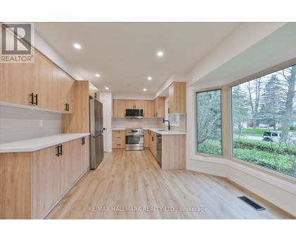A spacious kitchen with wooden cabinets and a central island.