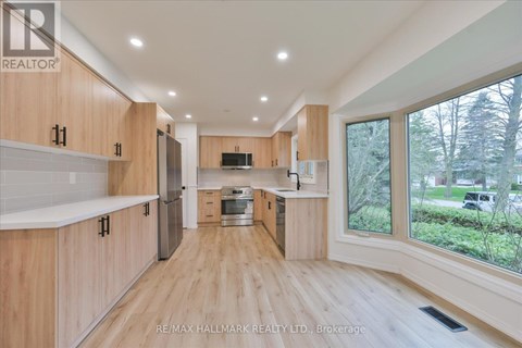 A spacious kitchen with wooden cabinets and a central island.