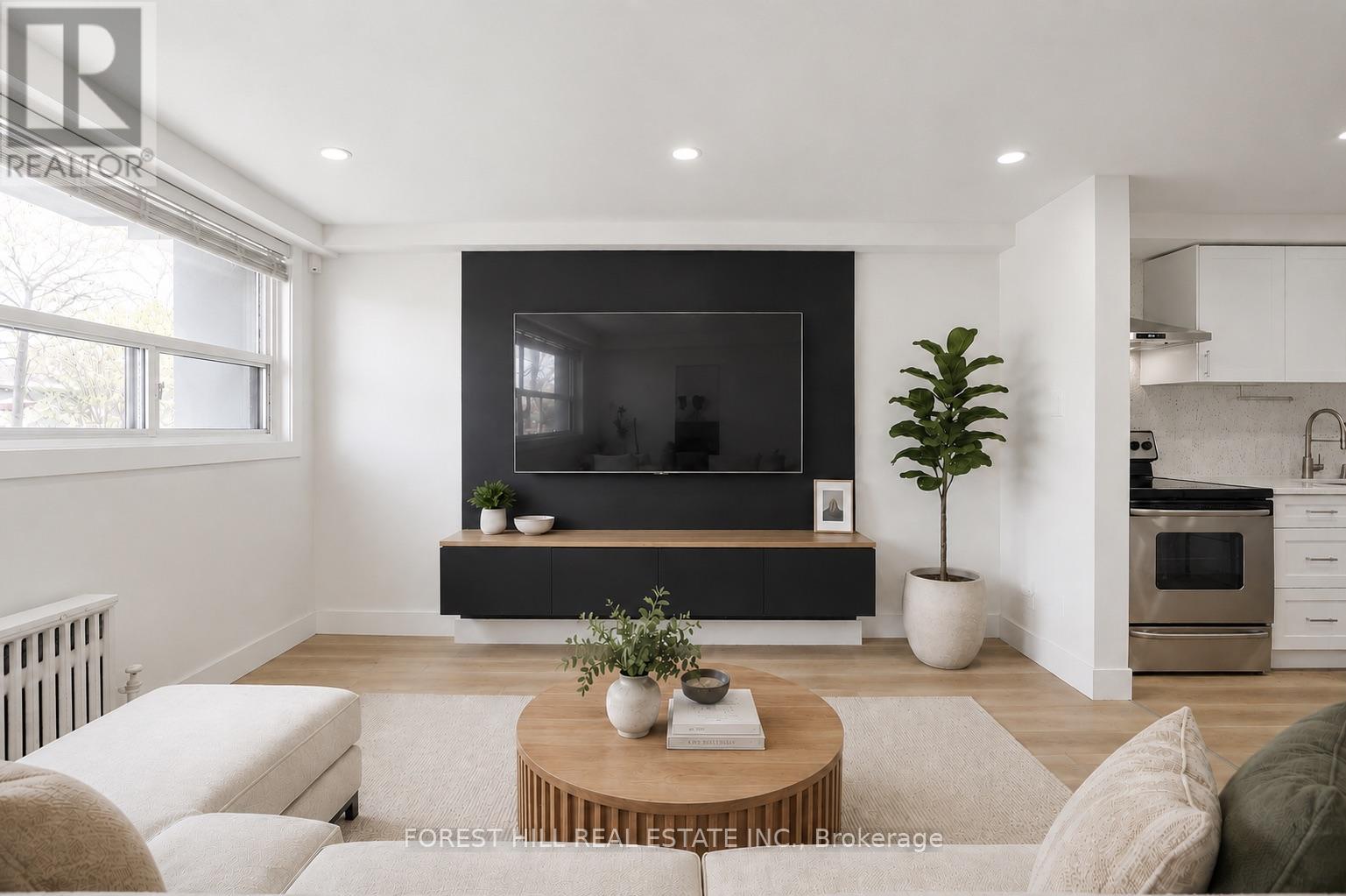 A modern living room with a flat screen TV and a coffee table.