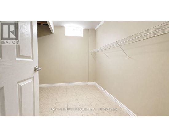 A white door with a glass window is set in a brick wall.