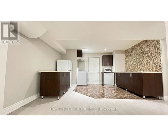 A kitchen with white appliances and brown cabinets.