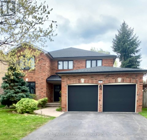 A house with a brick facade and a black garage door.