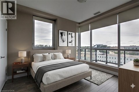 A bedroom with a large bed and a view of the city.