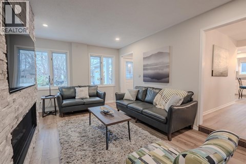 A living room with a grey couch and a coffee table.