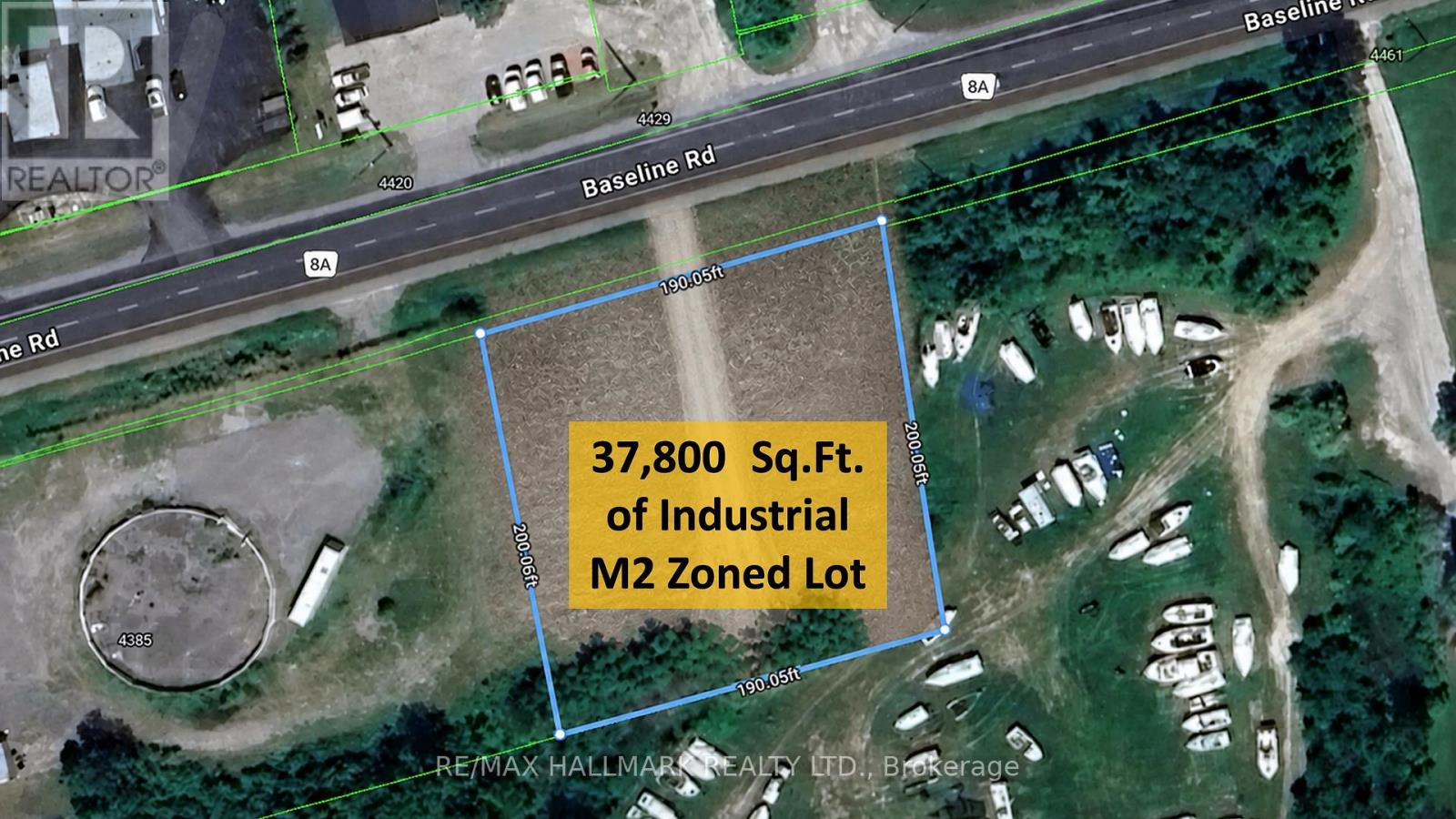 A satellite image shows a blue outlined area with a road and buildings in the background.