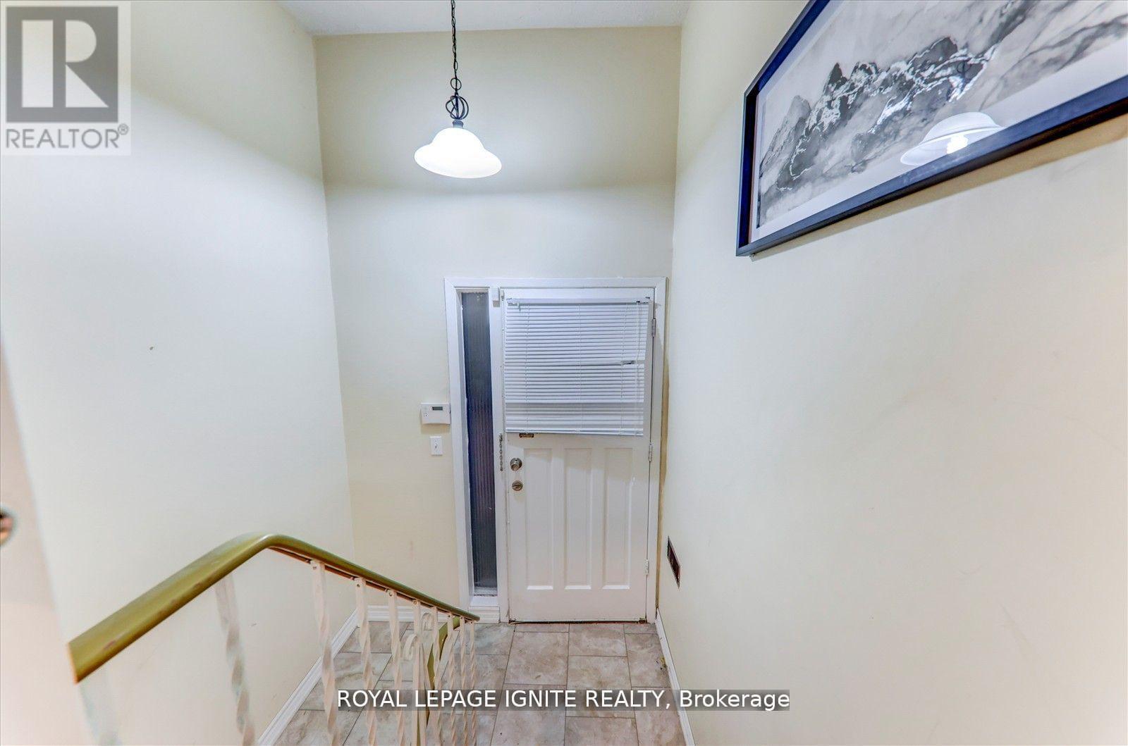 A hallway with a door and a painting on the wall.