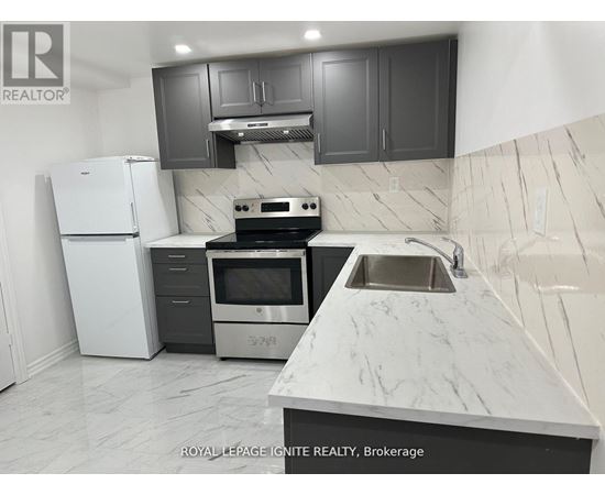 A kitchen with a white refrigerator, stove, and sink.