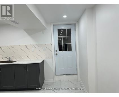 A white door with a glass window is in a room with white walls.