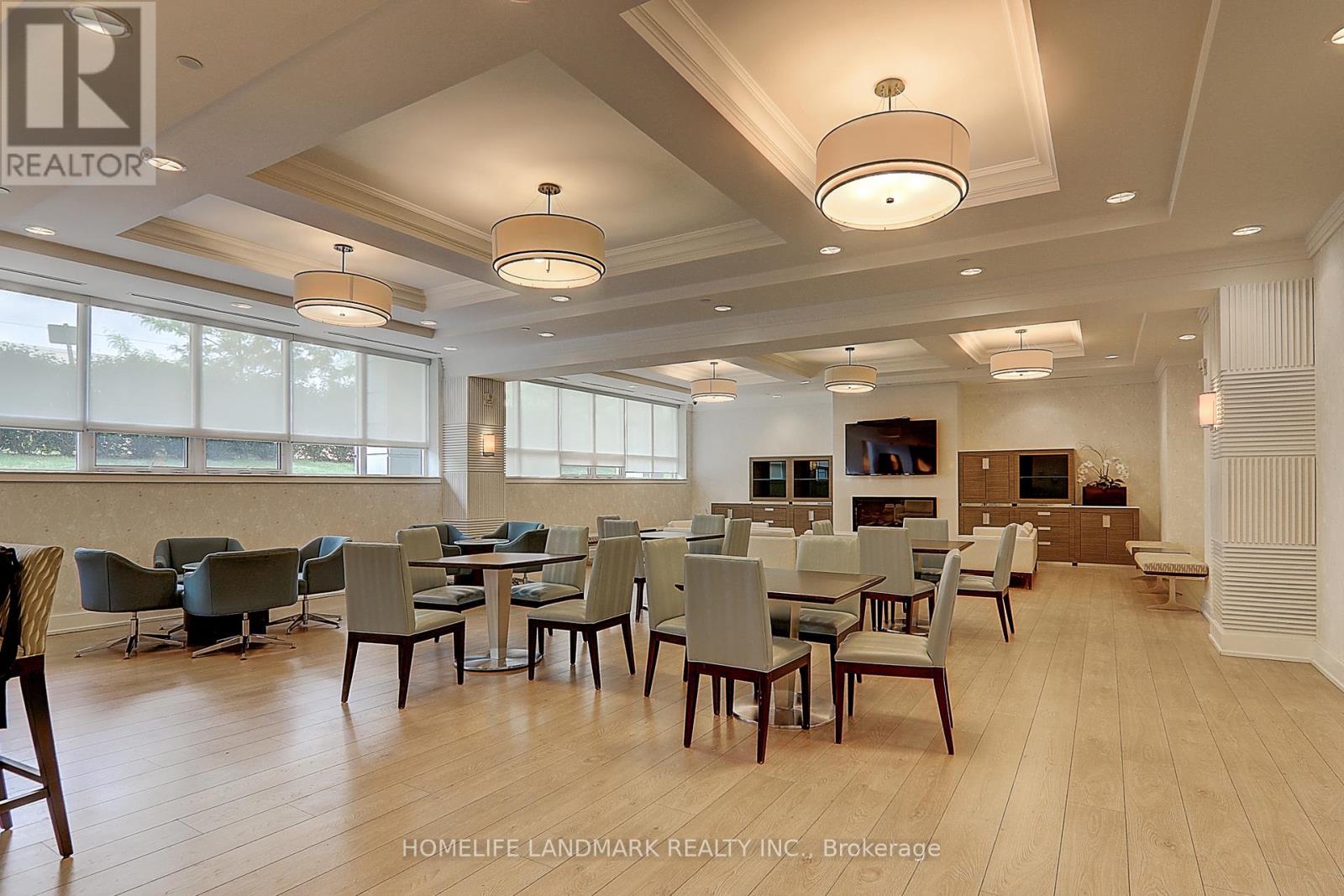 A dining room with a table set for six with chairs around it.