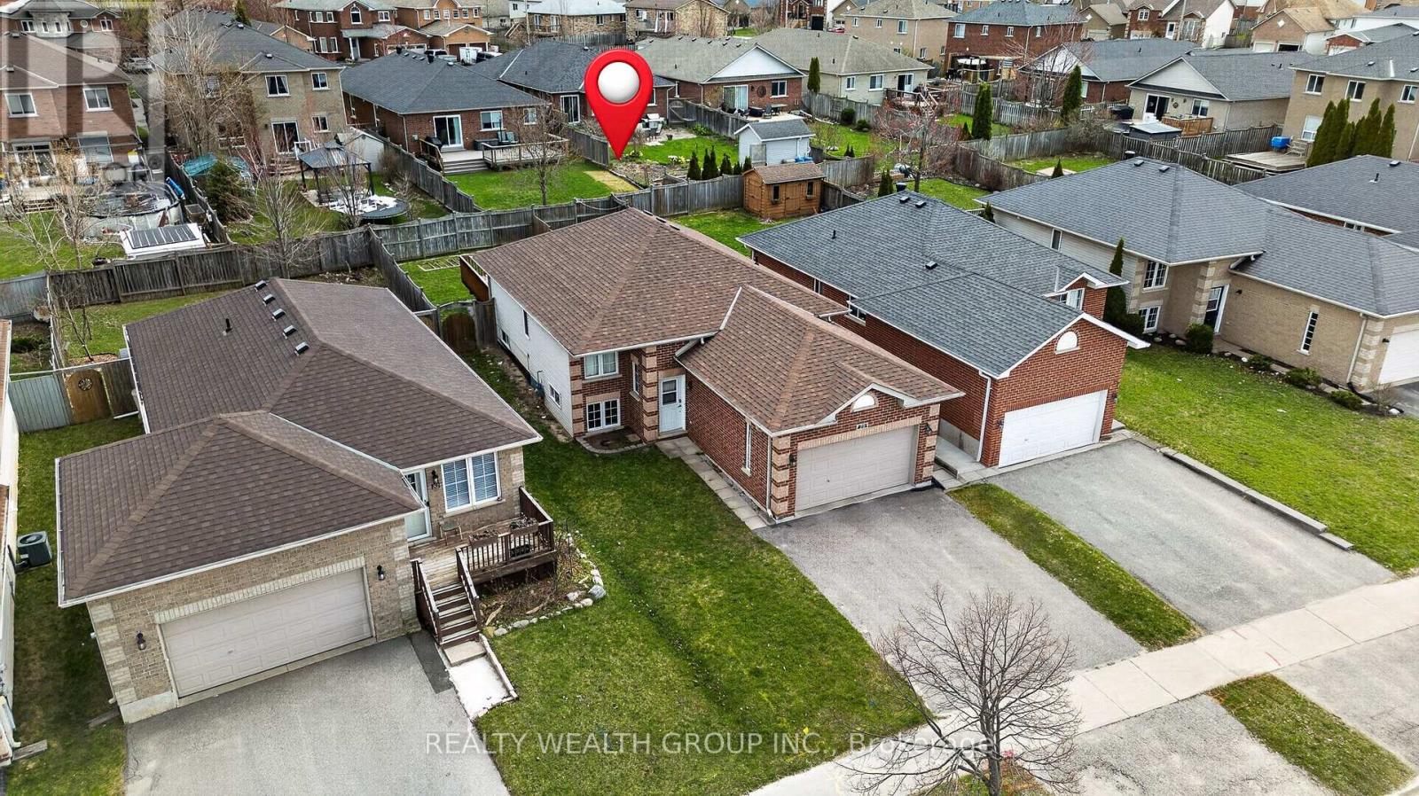 A bird's eye view of a neighborhood with a red pin on a house.