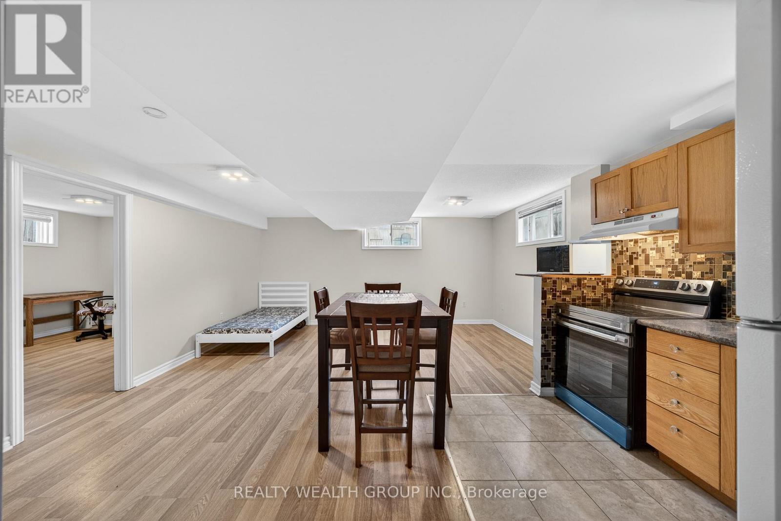 A kitchen with a table and chairs in the middle of the room.