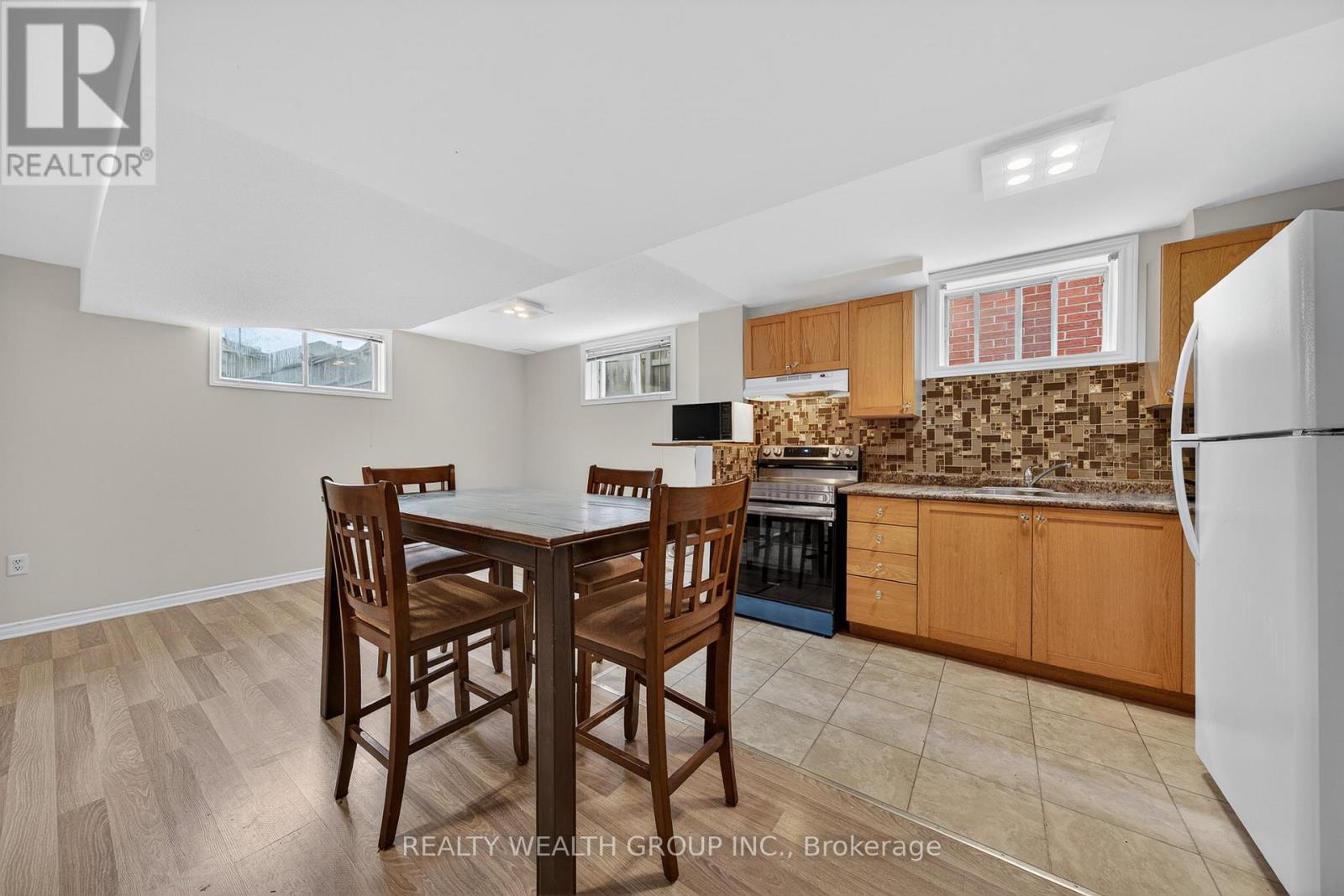 A kitchen with a table and chairs in the middle of the room.