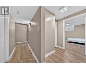 A bedroom with a bed and a dresser in a house.