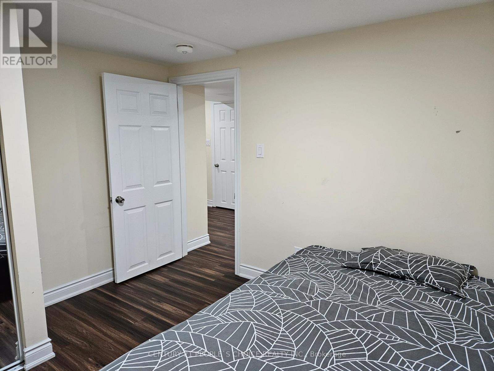 A bedroom with a bed and a door.