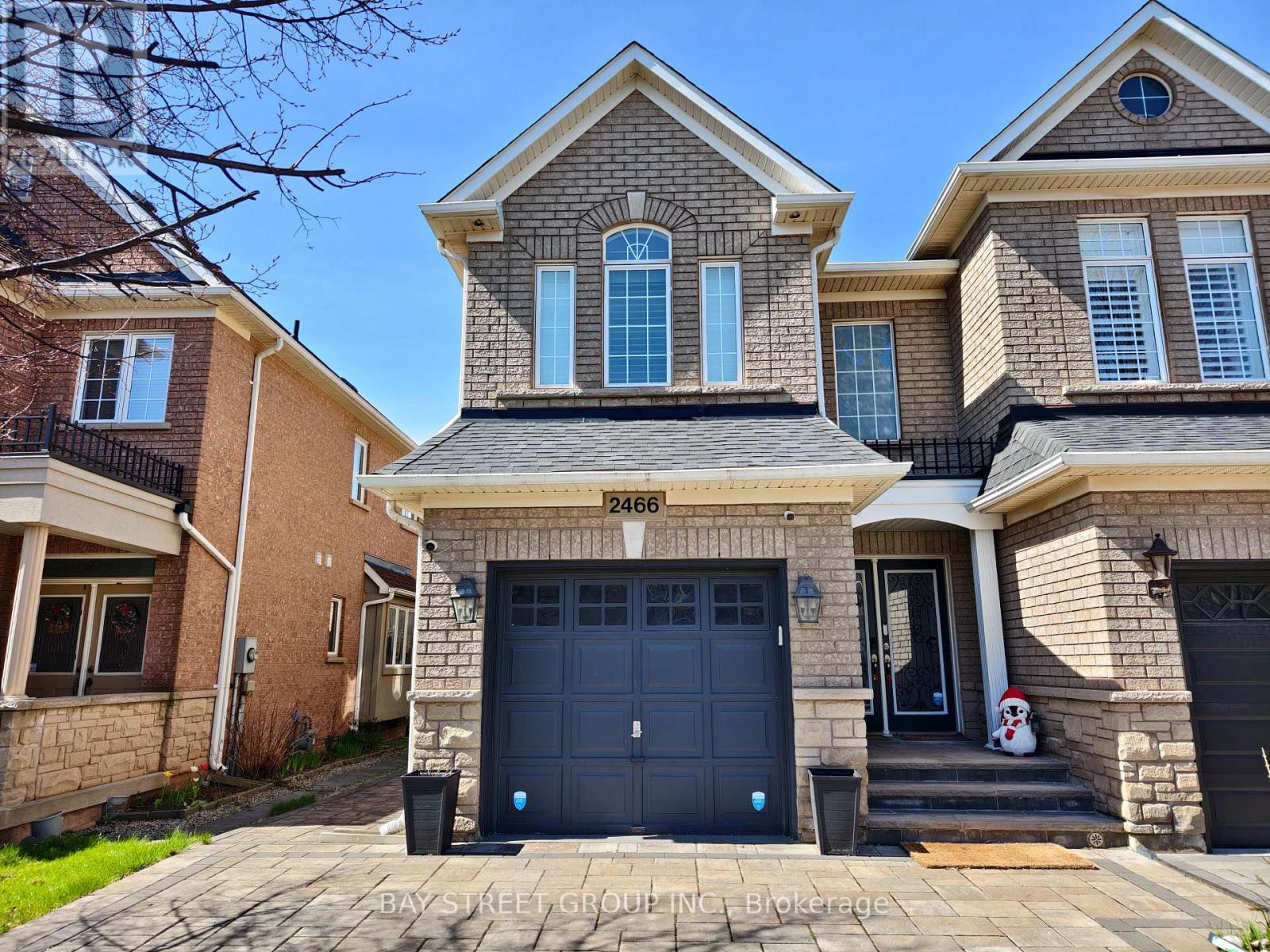 A two-story house with a garage is located at 2466 Bay Street.