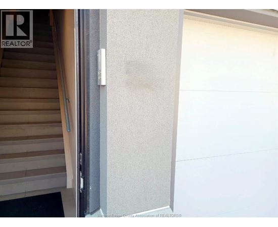 A white door with a handle and a window above it.