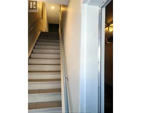 A staircase with a white door on the side.