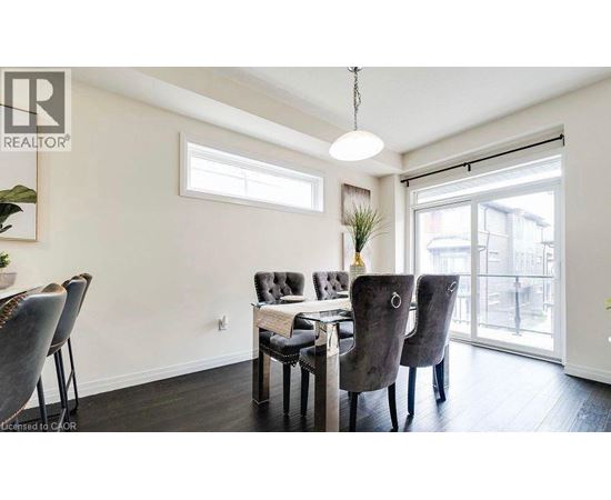 A dining room with a table and chairs.