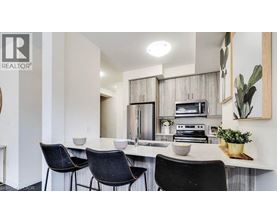 A modern kitchen with a dining table and chairs.