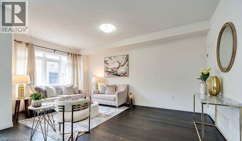 A well-lit living room with a white sofa and a coffee table.