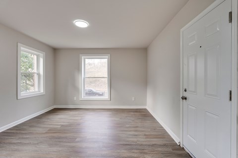 A room with a white door and a window.