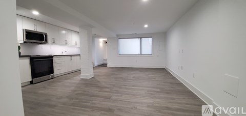 A spacious living room with a fireplace and a television mounted above it.