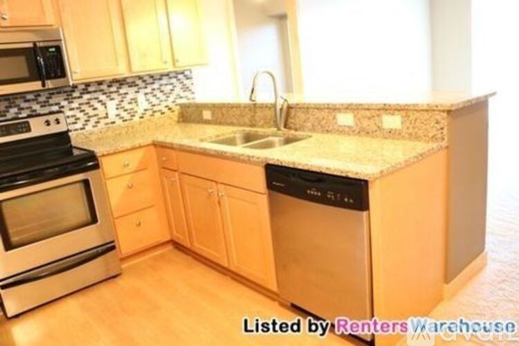 A kitchen with a black and white tile backsplash.