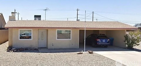 A house with a garage and a car parked in it.